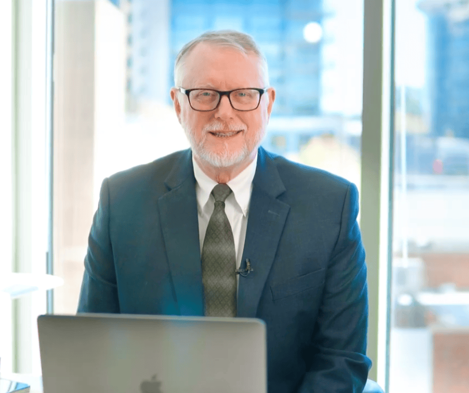 Dana founder of Woodlands Tax Advisors sitting at computer